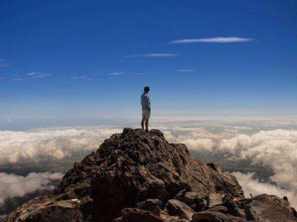 man standing on top of rock formation